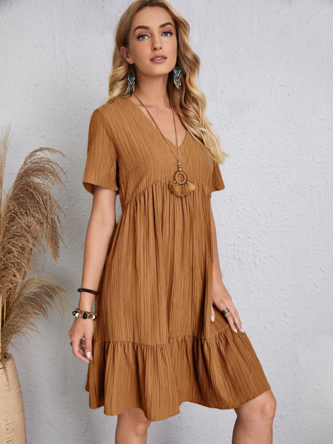 Relaxed fit brown dress with playful tiered design

