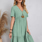 Relaxed fit green dress with playful tiered design

