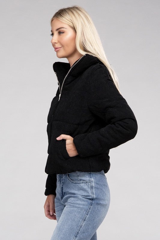 Woman wearing a casual black corduroy jacket with a zip-up front and high collar for a relaxed fall look.
