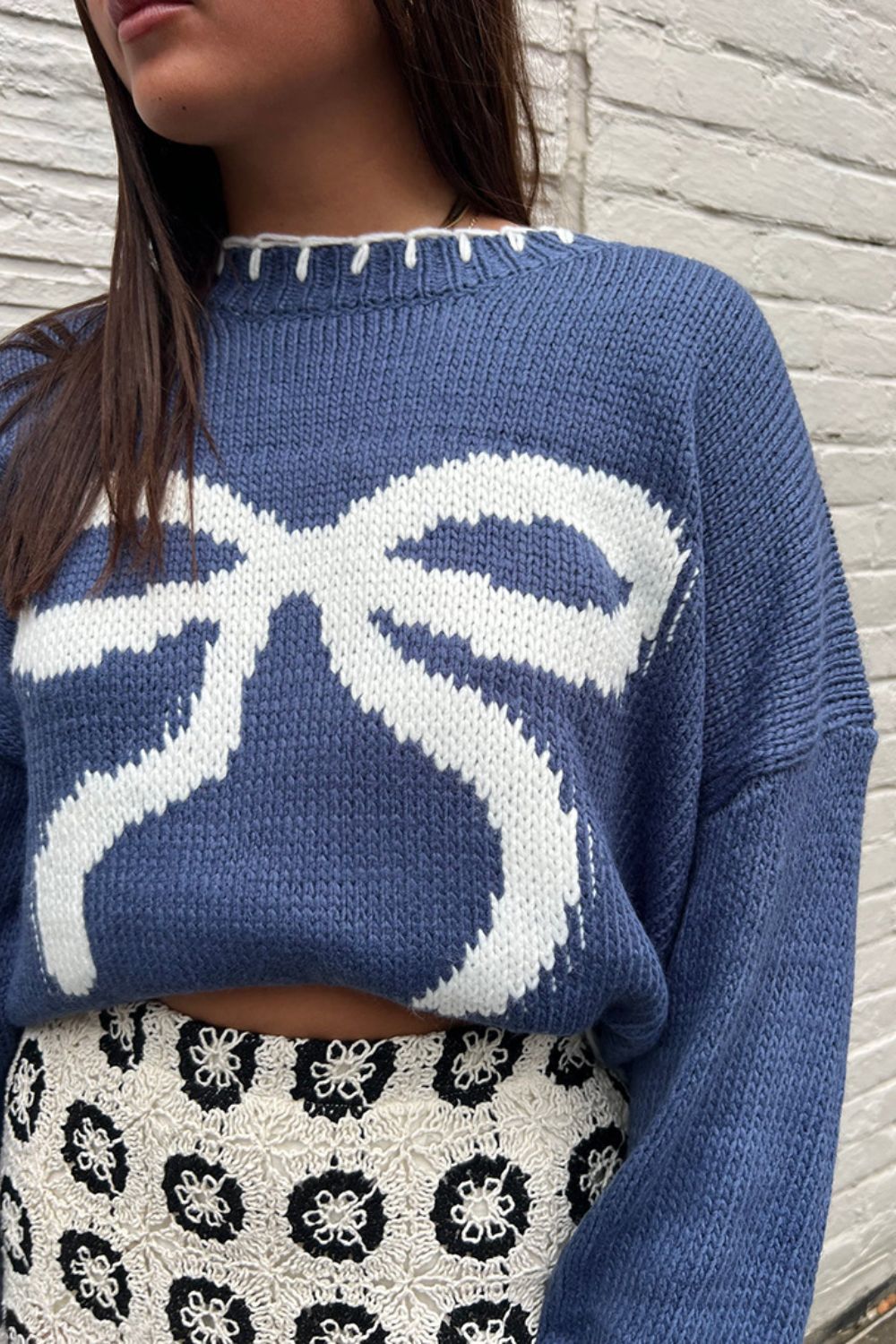 Casual blue knit sweater featuring a bow design, perfect for cozy and casual winter days.

