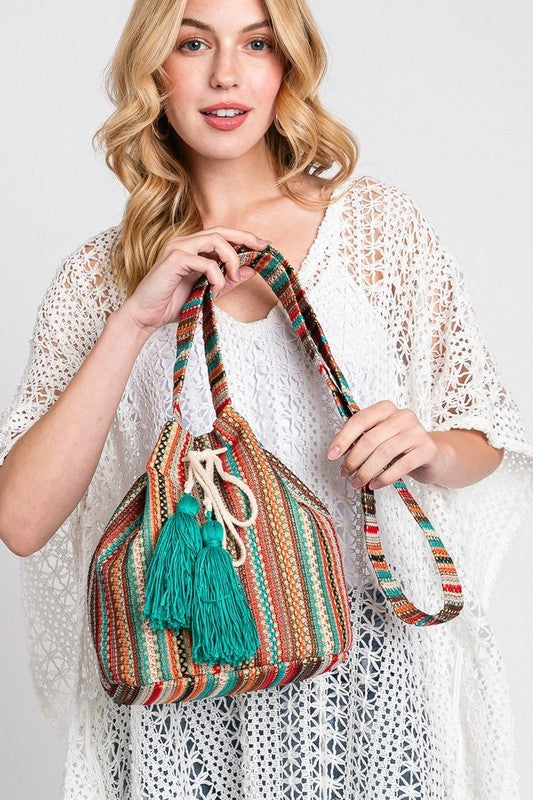 Spacious boho bucket bag with vibrant woven details and drawstring closure.
