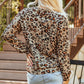 Back view of leopard print pumpkin graphic long sleeve top, perfect for fall fashion.
