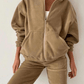 Closeup of the khaki sweater set made with woven polyester fabric.
