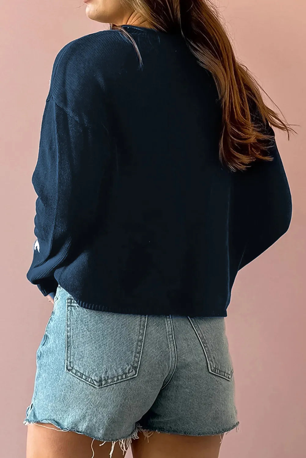 Casual navy sweater featuring a playful white star design, perfect for laid-back outfits.

