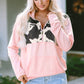 Trendy pink pullover with cow print detail across the chest
