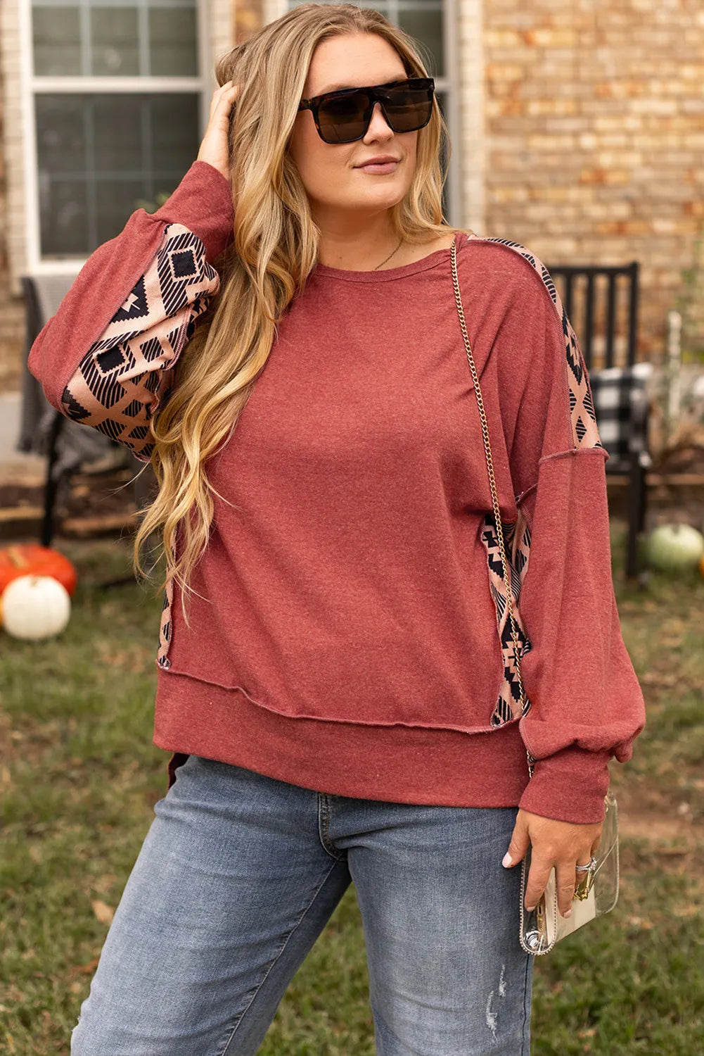 Casual plus-size geometric print sweatshirt styled for fall.
