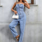 Trendy light wash denim jumpsuit with functional pockets and button closure.
