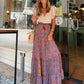 High-waisted red maxi skirt styled for summer outings or vacations.
