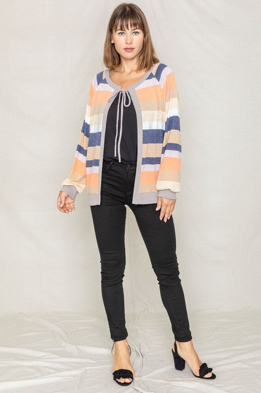 Olive cardigan featuring a tie-front design and colorful striped pattern.