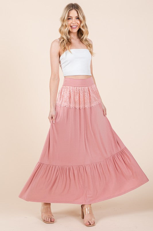 Rayon and spandex lace-trimmed maxi skirt in solid color.
