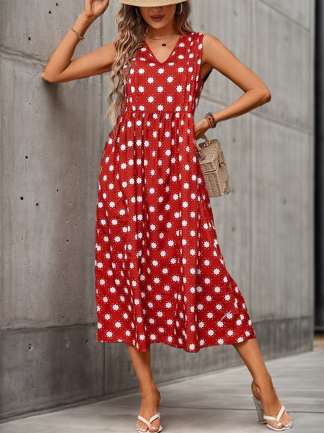 Flowy red dress featuring a daisy print and V-neckline.
