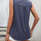 Elegant sleeveless top in blue with lace and buttons.