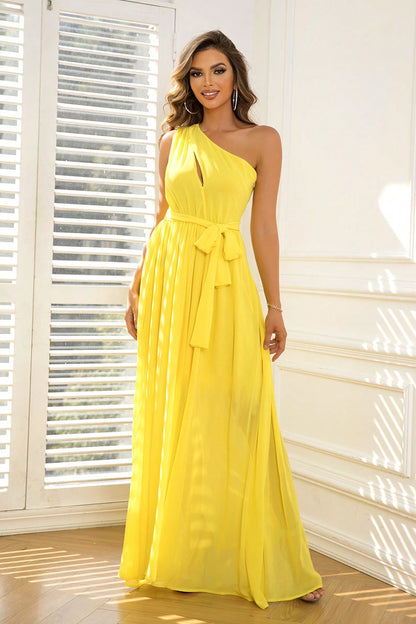 stunning yellow bridesmaid dress with a one-shoulder design and a ribbon belt at the waist