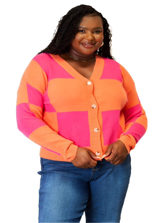 Bold orange and pink checkered cardigan with V-neck and dropped shoulders, perfect for layering.
