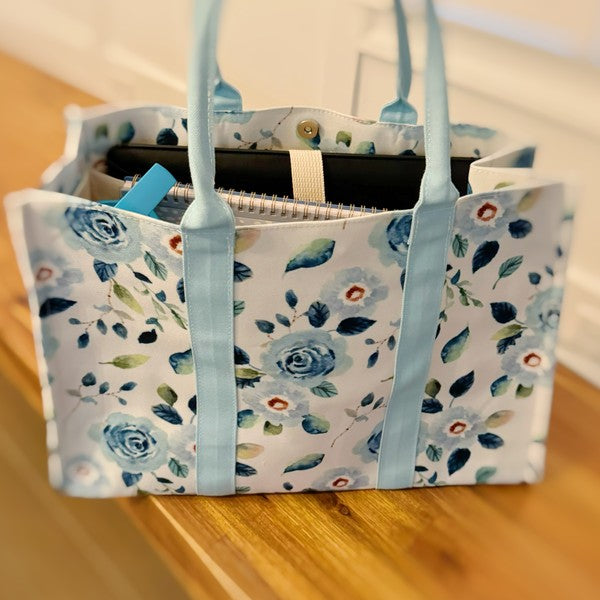 Side view of chic blue floral tote bag showing sturdy construction.
