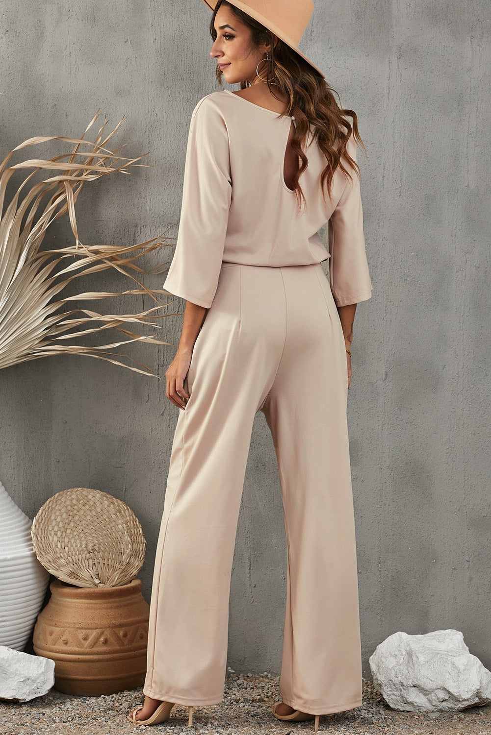 Chic boat neck jumpsuit in apricot with a keyhole back and flattering fit.
