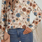 Chic boho-style khaki top with a classic crew neck and floral details.
