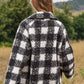 Chic boucle plaid coat for women, featuring side pockets and a lapel neck.
