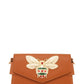 Stylish camel bag with bee embellishment and compact, functional design.
