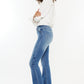 Side view of Kancan frayed hem jeans, emphasizing the high-rise fit.
