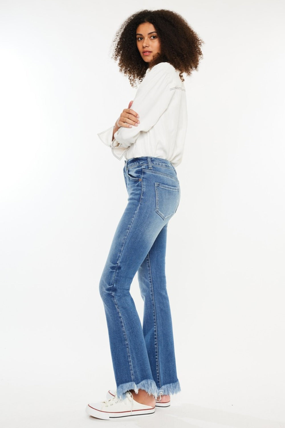 Side view of Kancan frayed hem jeans, emphasizing the high-rise fit.
