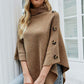 Cozy caramel turtleneck poncho with a chic, relaxed fit.
