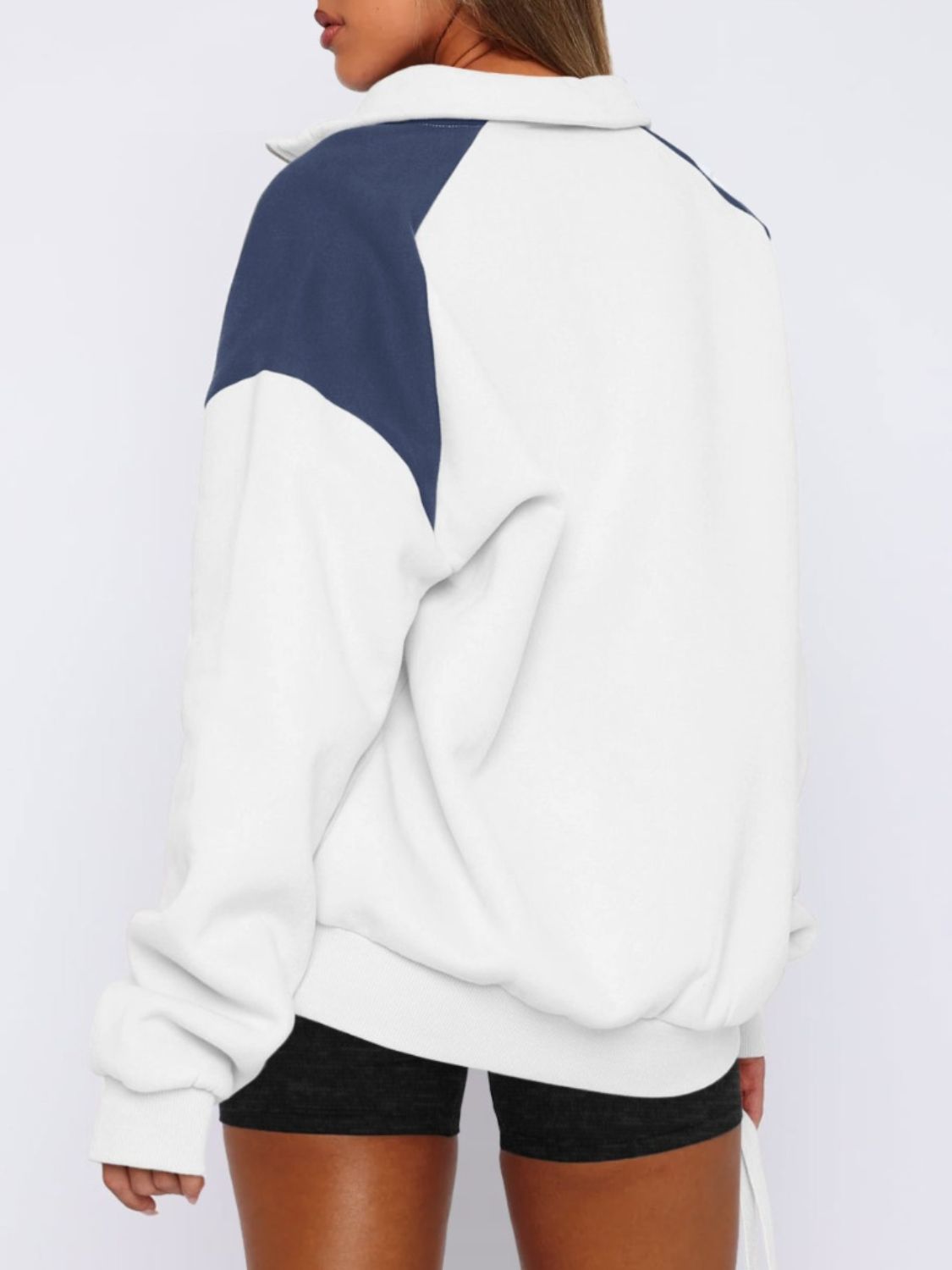 Stylish white color block half-zip sweatshirt for women.
