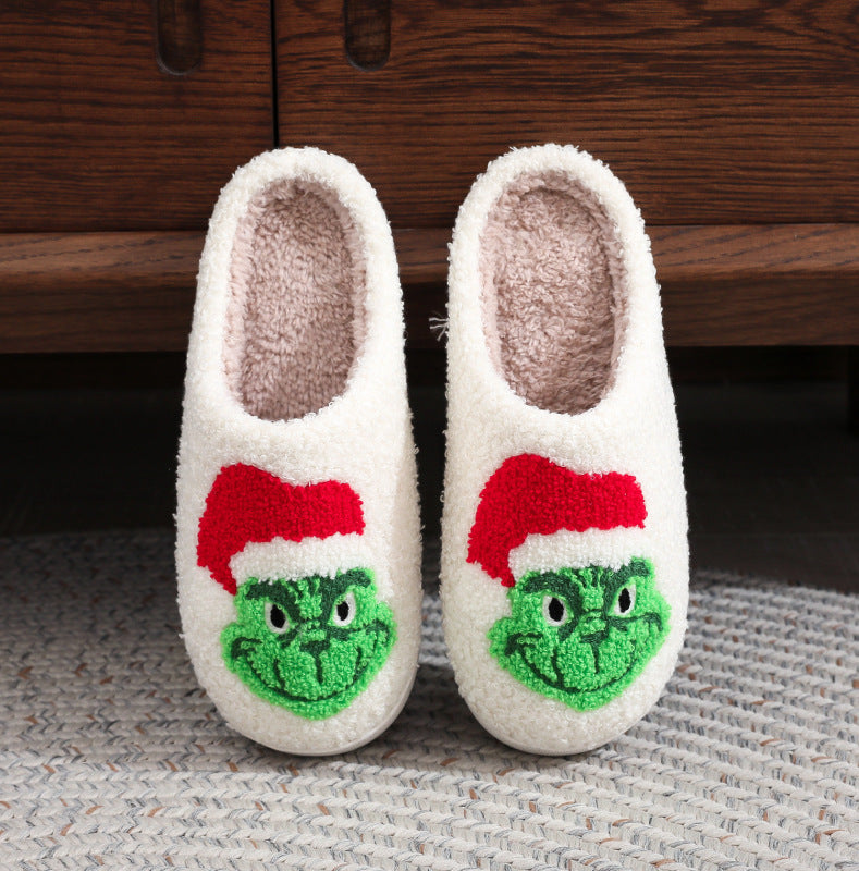 Festive Grinch Christmas slippers featuring a Santa hat design.
