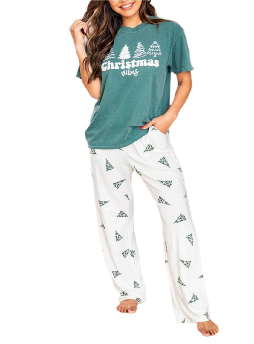 Cozy women’s lounge set featuring a Christmas vibes graphic tee and printed pants.
