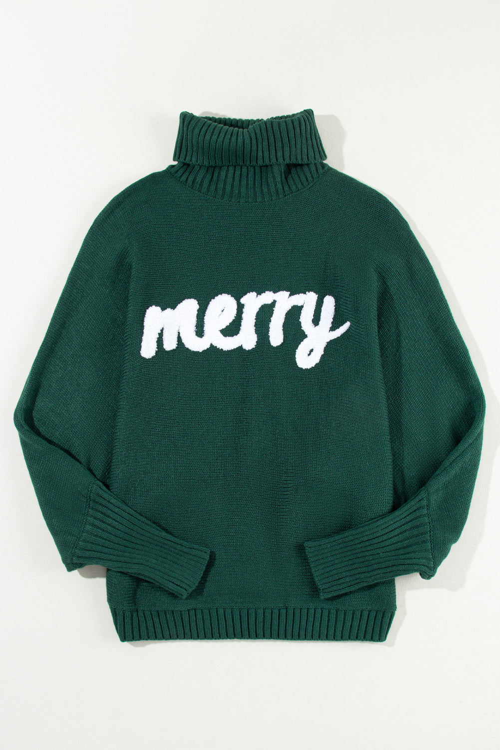 Close-up of the turtleneck and embroidered lettering on a Christmas sweater
