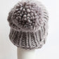 Stylish gray knit hat with a chunky cable pattern, made from durable acrylic