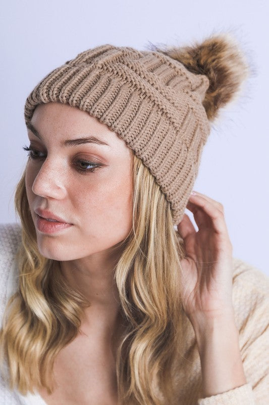 Comfortable tan beanie featuring intricate braided design

