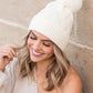 White chunky knit beanie with a soft stretchy fit and faux fur pom
