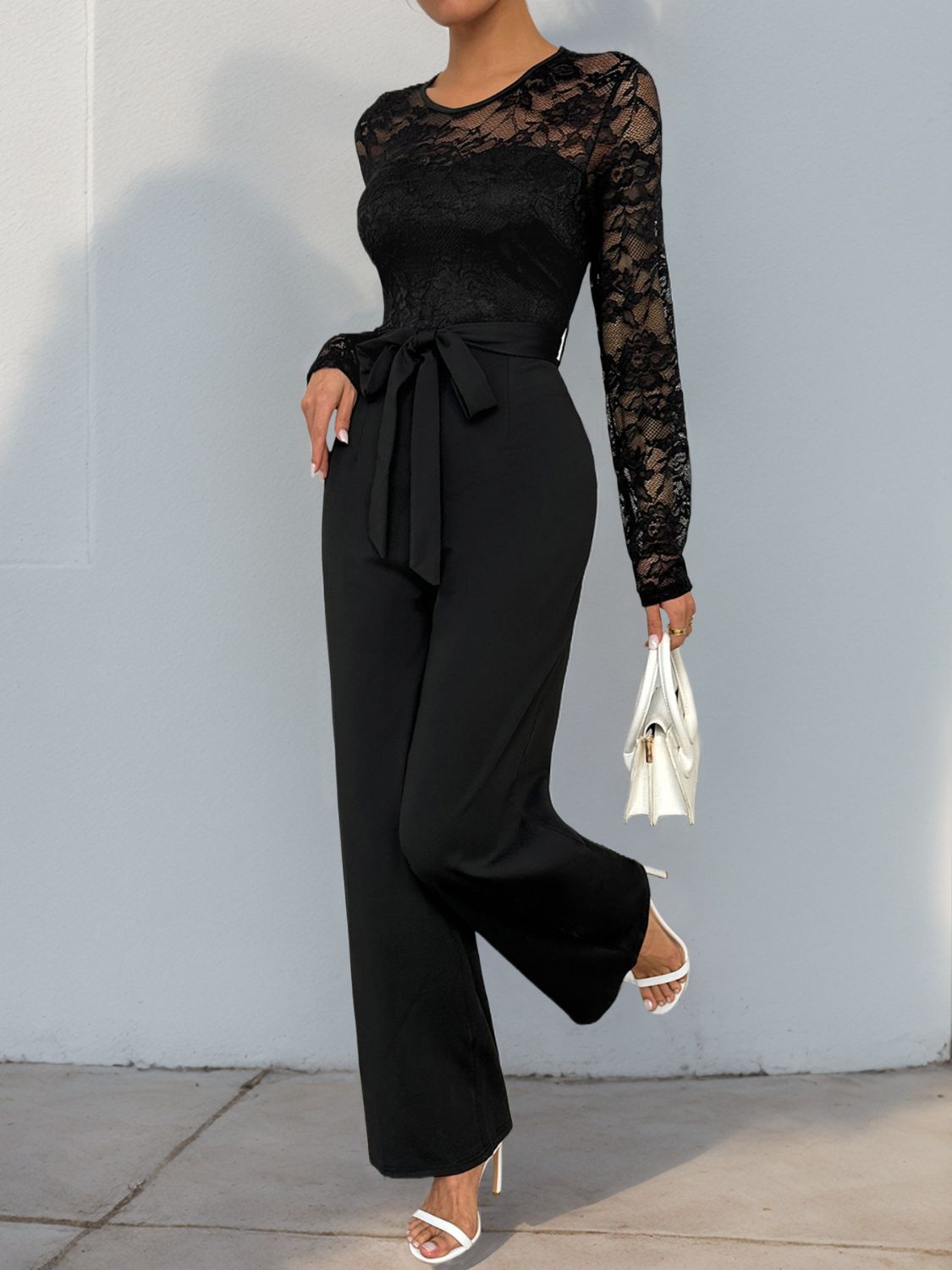 Elegant black jumpsuit with lace detailing, perfect for formal events.