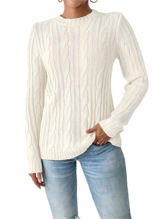 Woman wearing an ivory cable knit sweater styled with distressed jeans