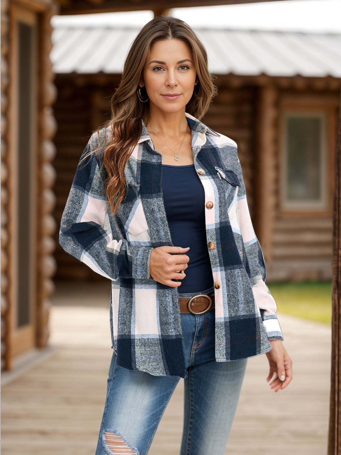 Woman wearing a navy plaid button-up shirt with jeans.
