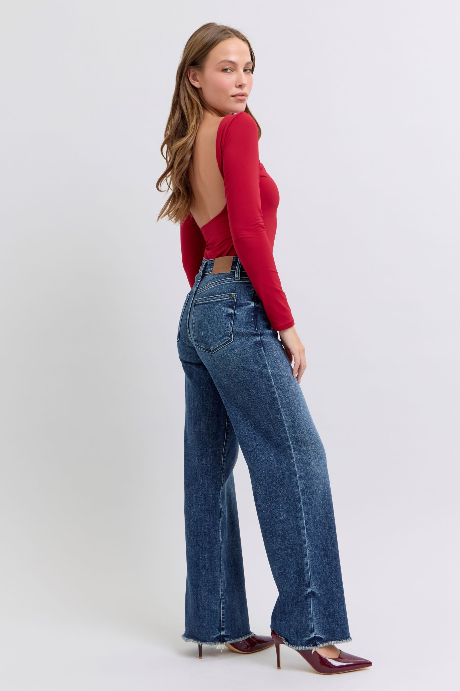 Flattering raw hem jeans in a medium wash for versatile styling
