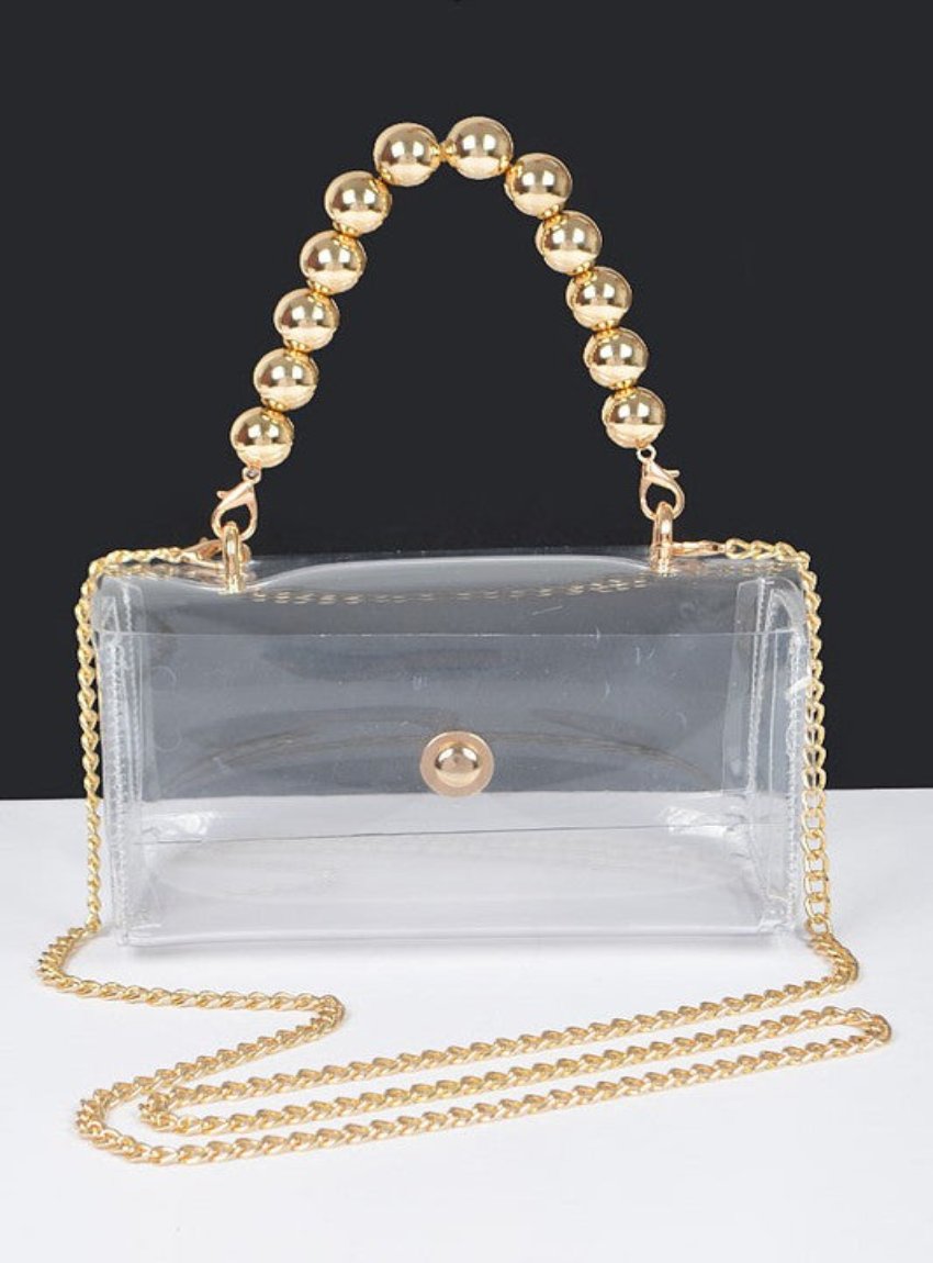 Stylish clear bag featuring a gold beaded handle and chain strap.