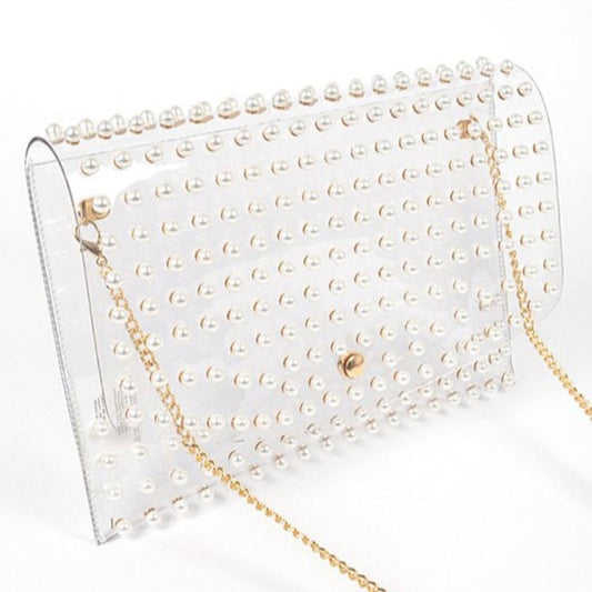 Clear clutch with pearl-like studs and gold chain strap.