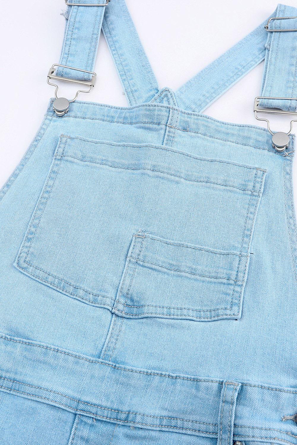 Edgy distressed denim light wash overalls paired with a casual white tank top.
