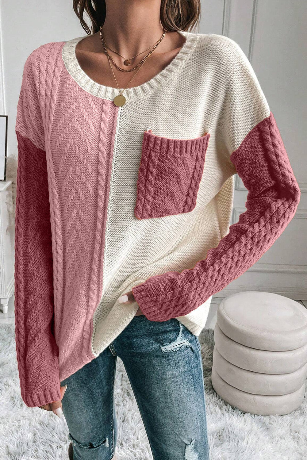 Pink color block cable knit sweater with pocket detail for a cozy look.
