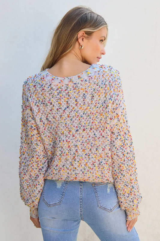 Casual confetti knit sweater with multicolored speckles and ribbed hem