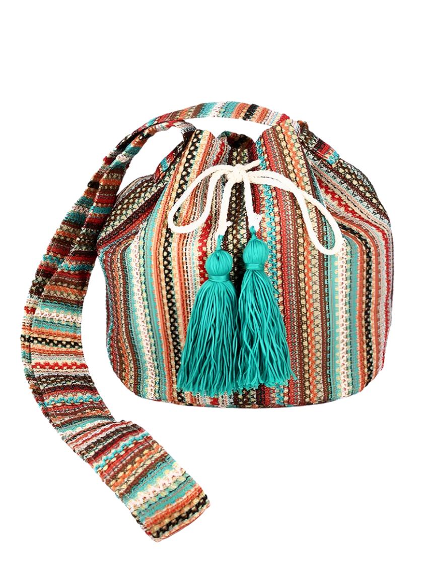 Front view of colorful tassel boho bucket bag with woven design and drawstring closure.
