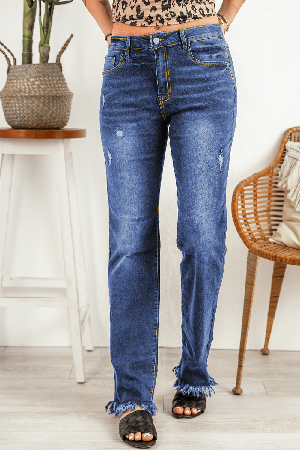 Stylish high waist straight-leg jeans with raw hem and distressing.
