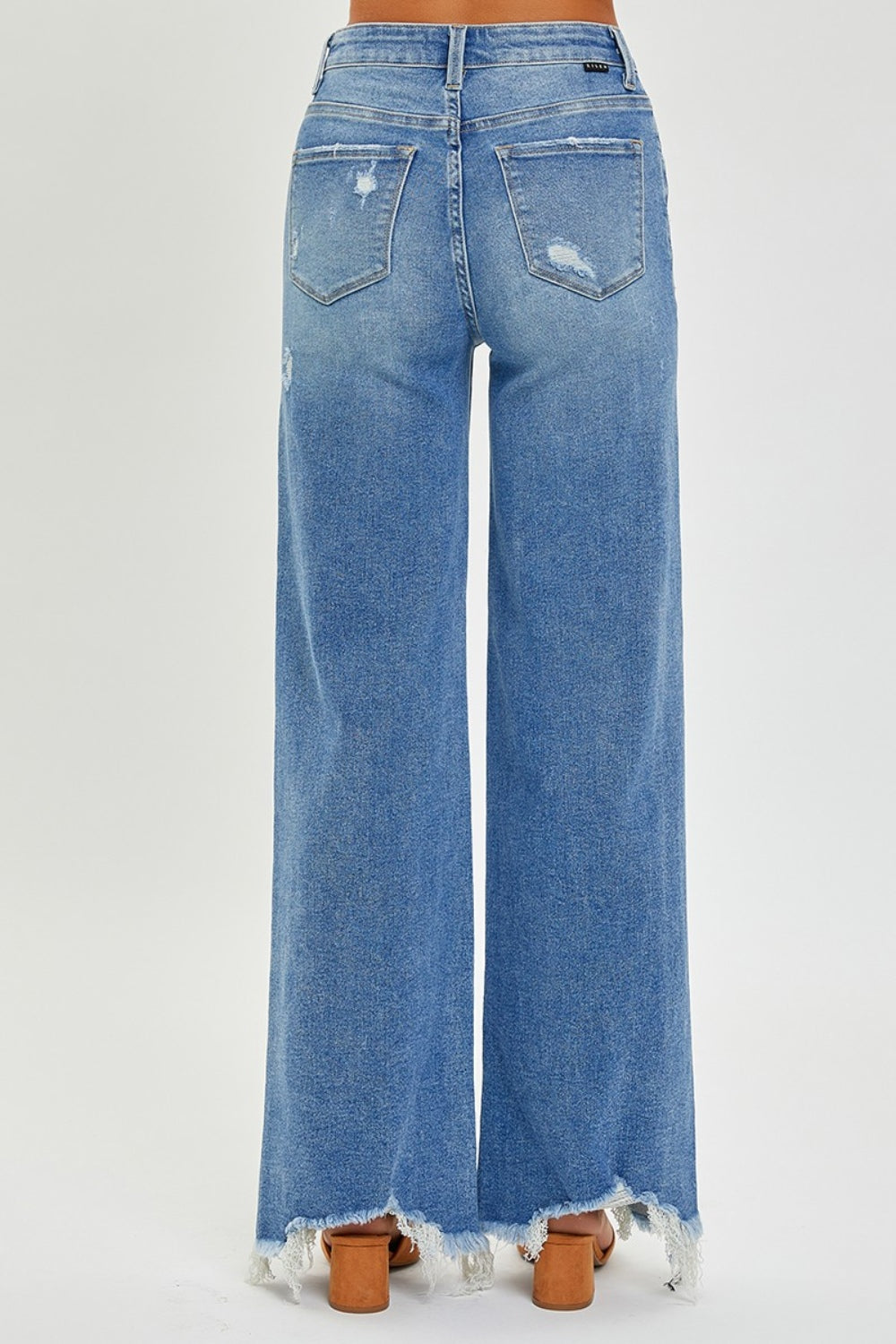 High-rise wide leg jeans with frayed hem in medium-wash denim
