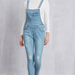 Comfortable pocketed distressed denim light wash overalls in a relaxed, everyday fit.
