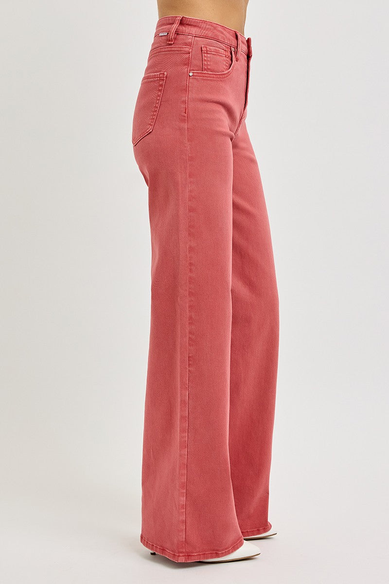 Women's high-rise jeans with tummy control, styled with white pointed-toe heels.
