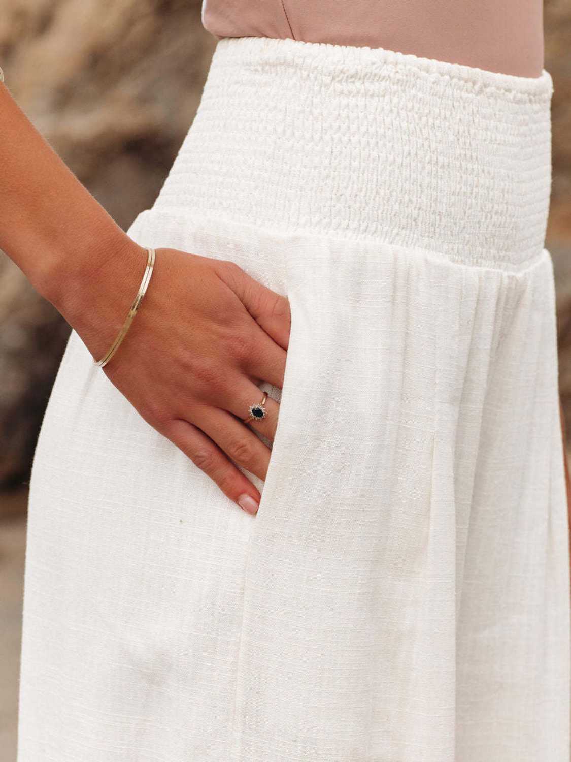 Relaxed fit white wide leg pants with smocked waistband