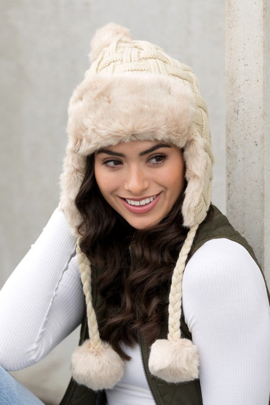 Comfortable winter hat with cable weave and pom design
