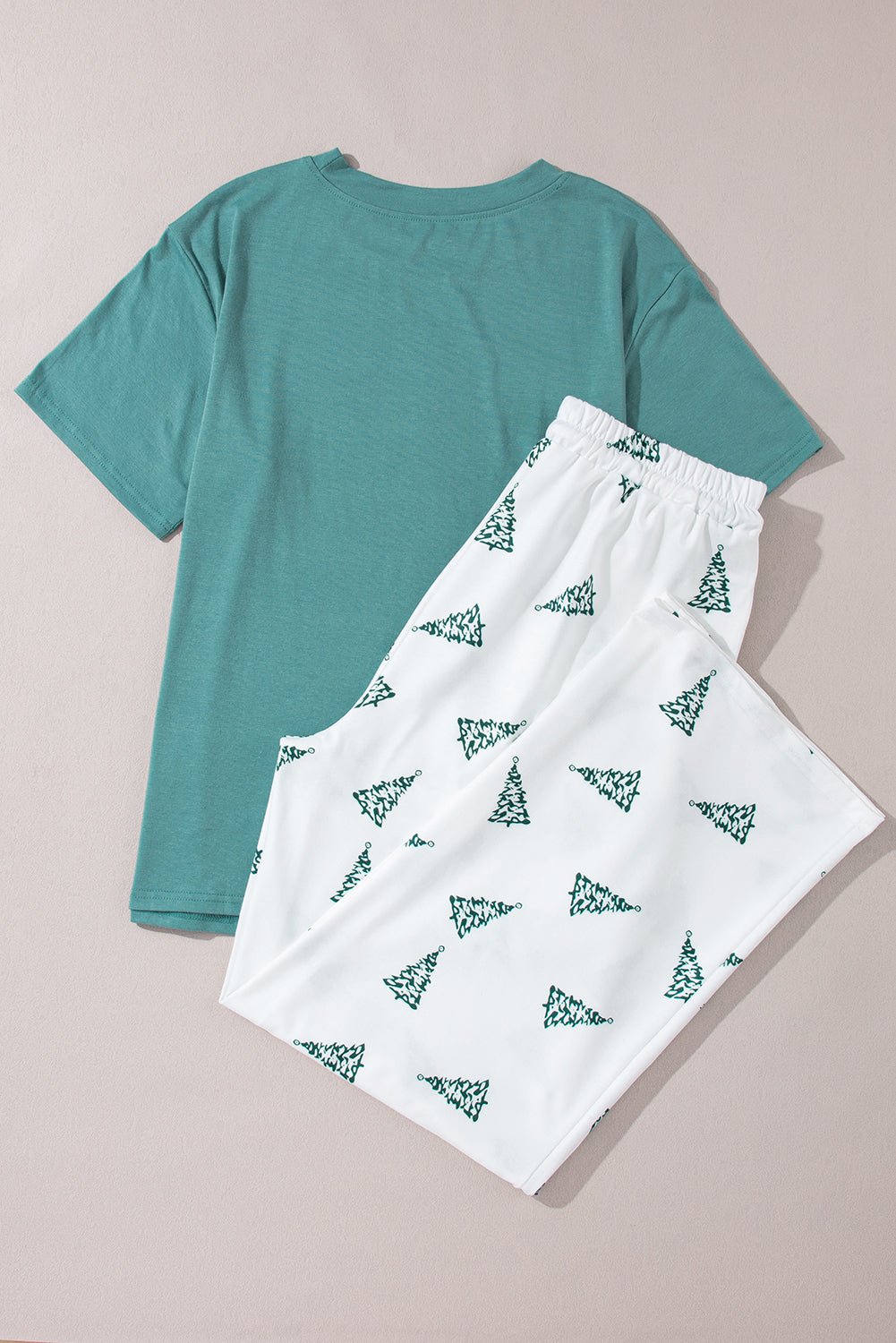 Women’s two-piece lounge set with a Christmas vibes graphic tee and tree print pants.
